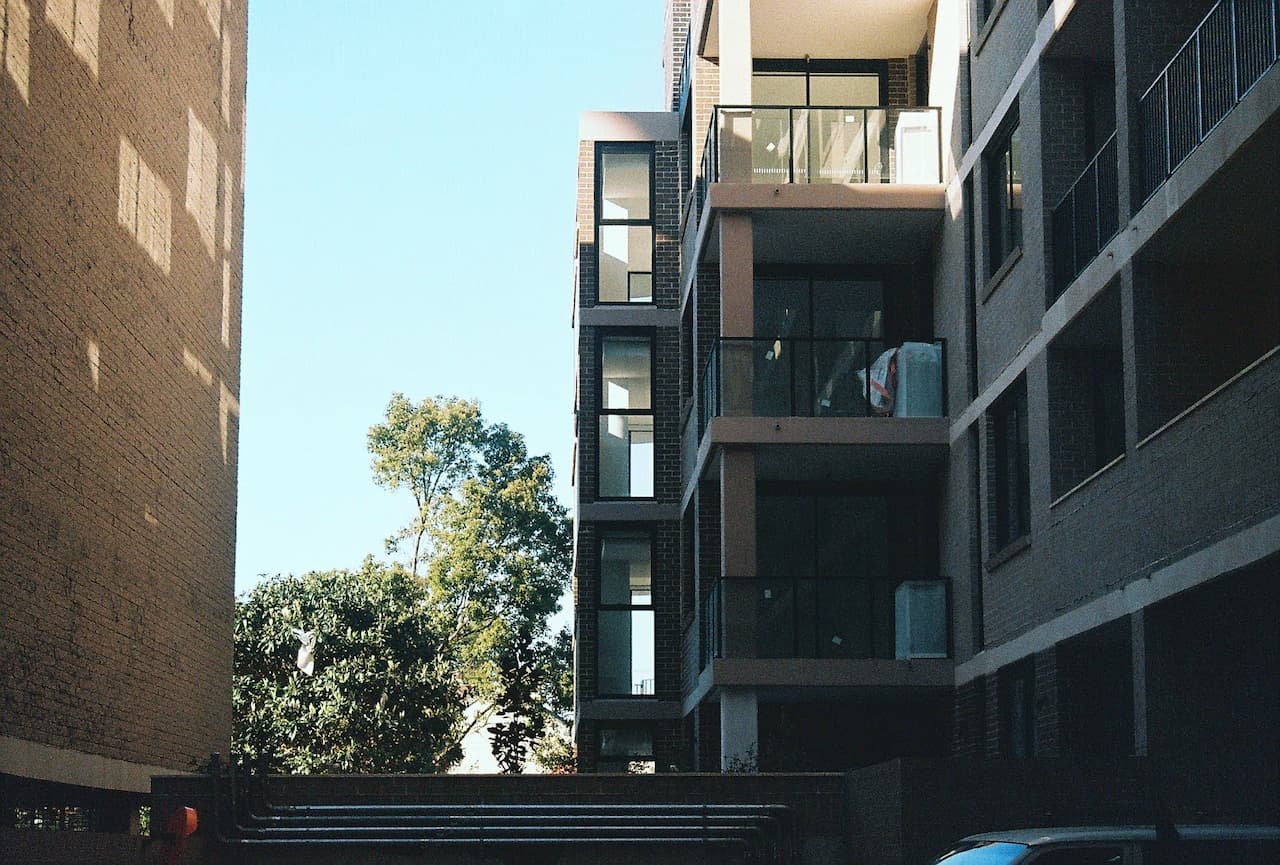 Photograph of a nearly-complete apartment block in Sydney against a blue sky